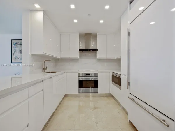 a kitchen with stainless steel appliances granite countertop a stove and a sink