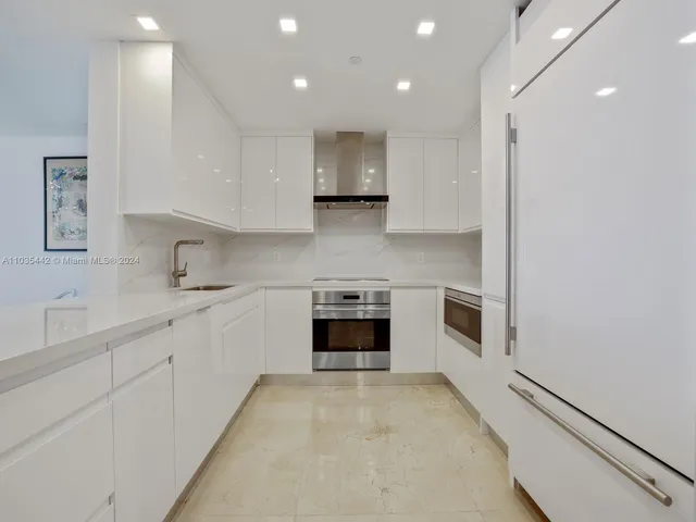 a kitchen with stainless steel appliances granite countertop a stove and a sink
