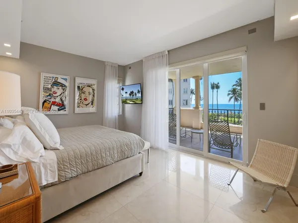 a spacious bedroom with a bed and a chair