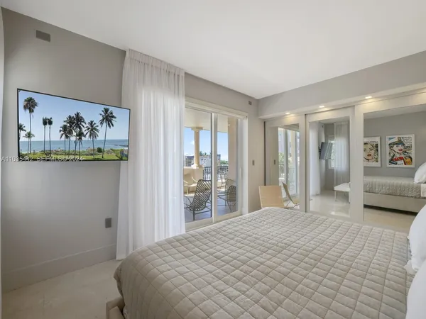 a bedroom with a large bed and a couch