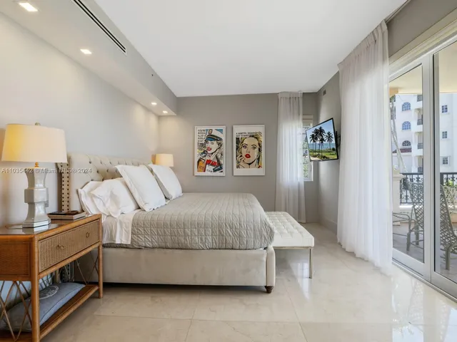 a spacious bedroom with a bed and a lamp