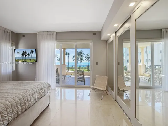 a bedroom with a large bed and a large window with outer view