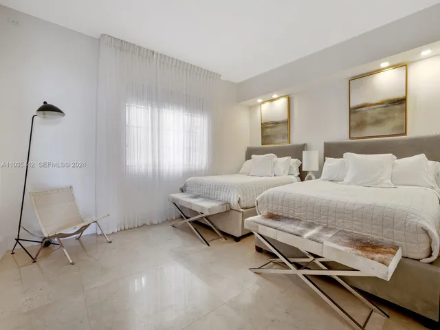 a bathroom with a toilet a sink a mirror and shower