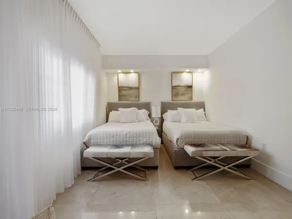 a bedroom with a bed and glass door