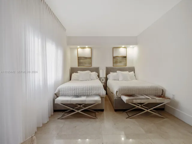 a bedroom with a bed and glass door