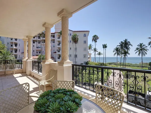 a view of a balcony with chairs and wooden floor