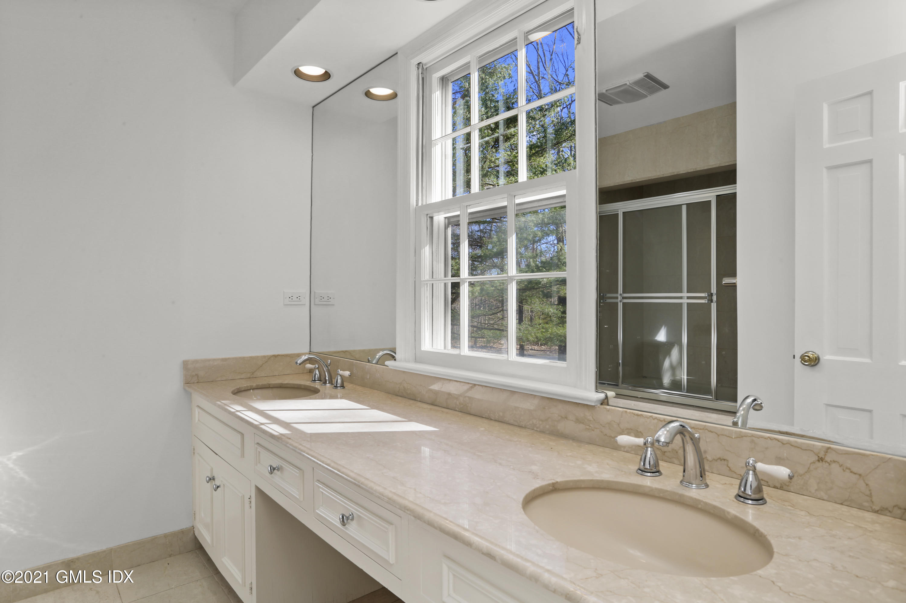 99 Hunting Ridge Road Greenwich, CT 06831 - Photo 17 of 23 a bathroom with a granite countertop sink a mirror and a window