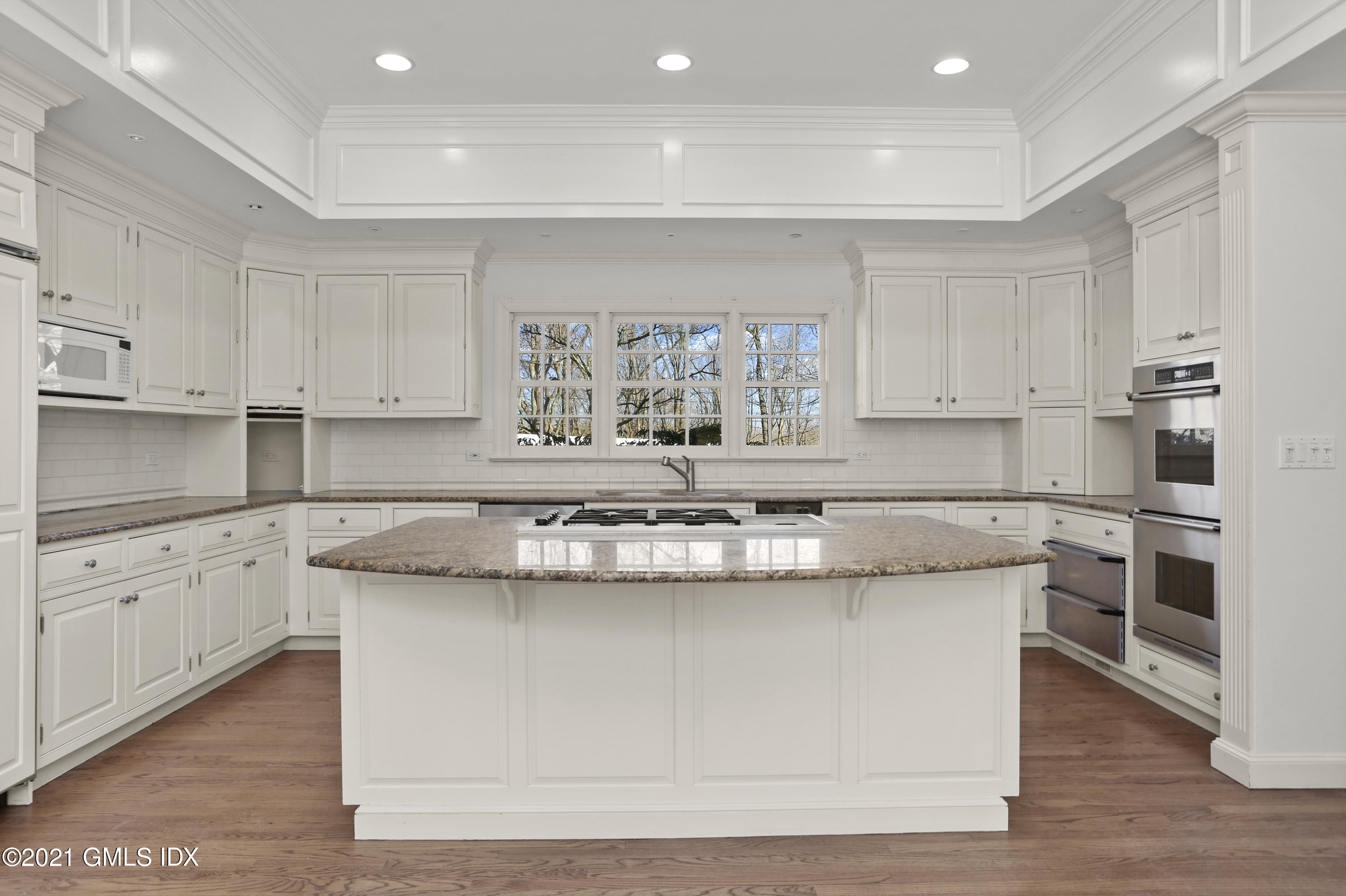 99 Hunting Ridge Road Greenwich, CT 06831 - Photo 4 of 23 a kitchen with stainless steel appliances granite countertop a stove a sink and white cabinets