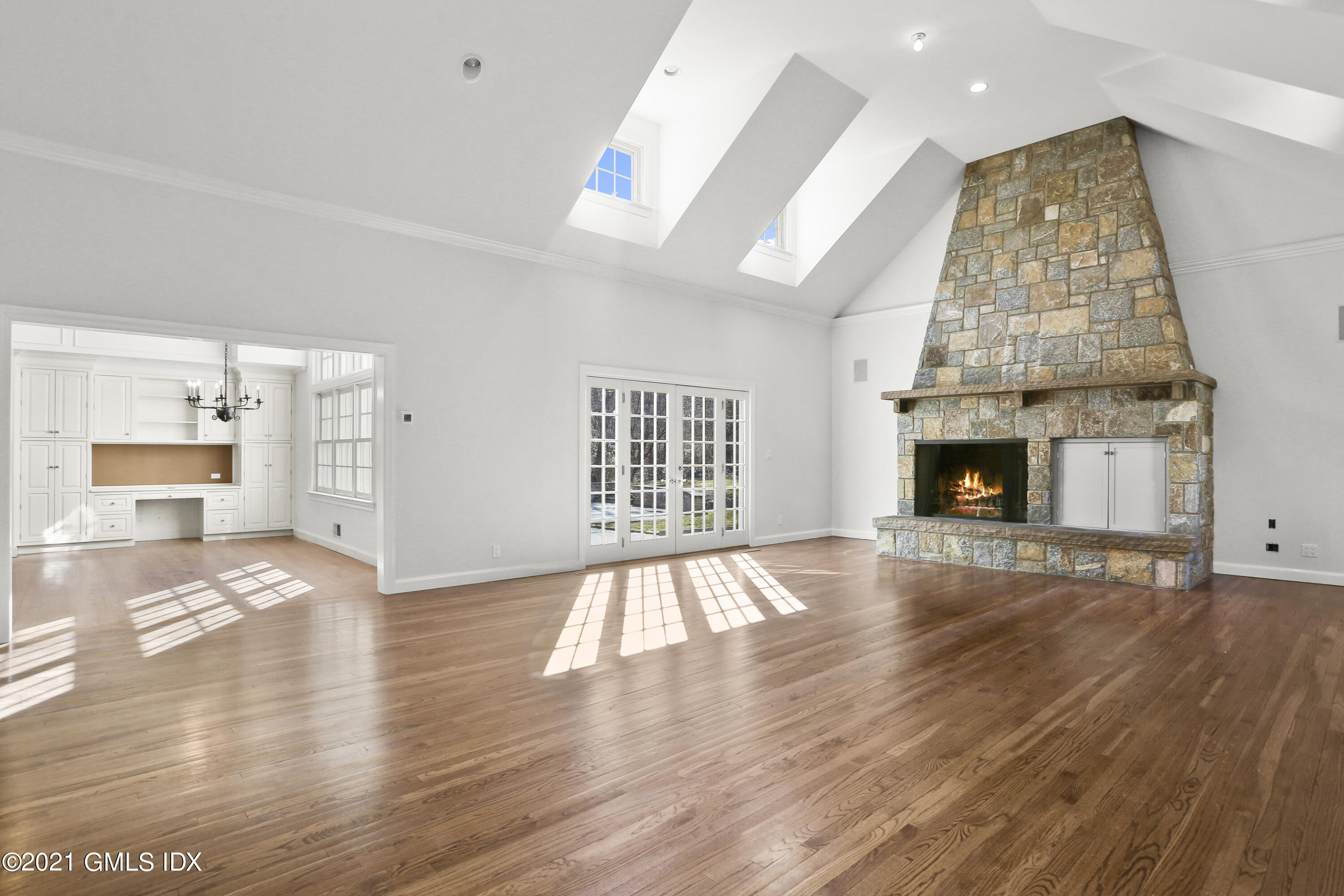 99 Hunting Ridge Road Greenwich, CT 06831 - Photo 7 of 23 an empty room with wooden floor and fireplace