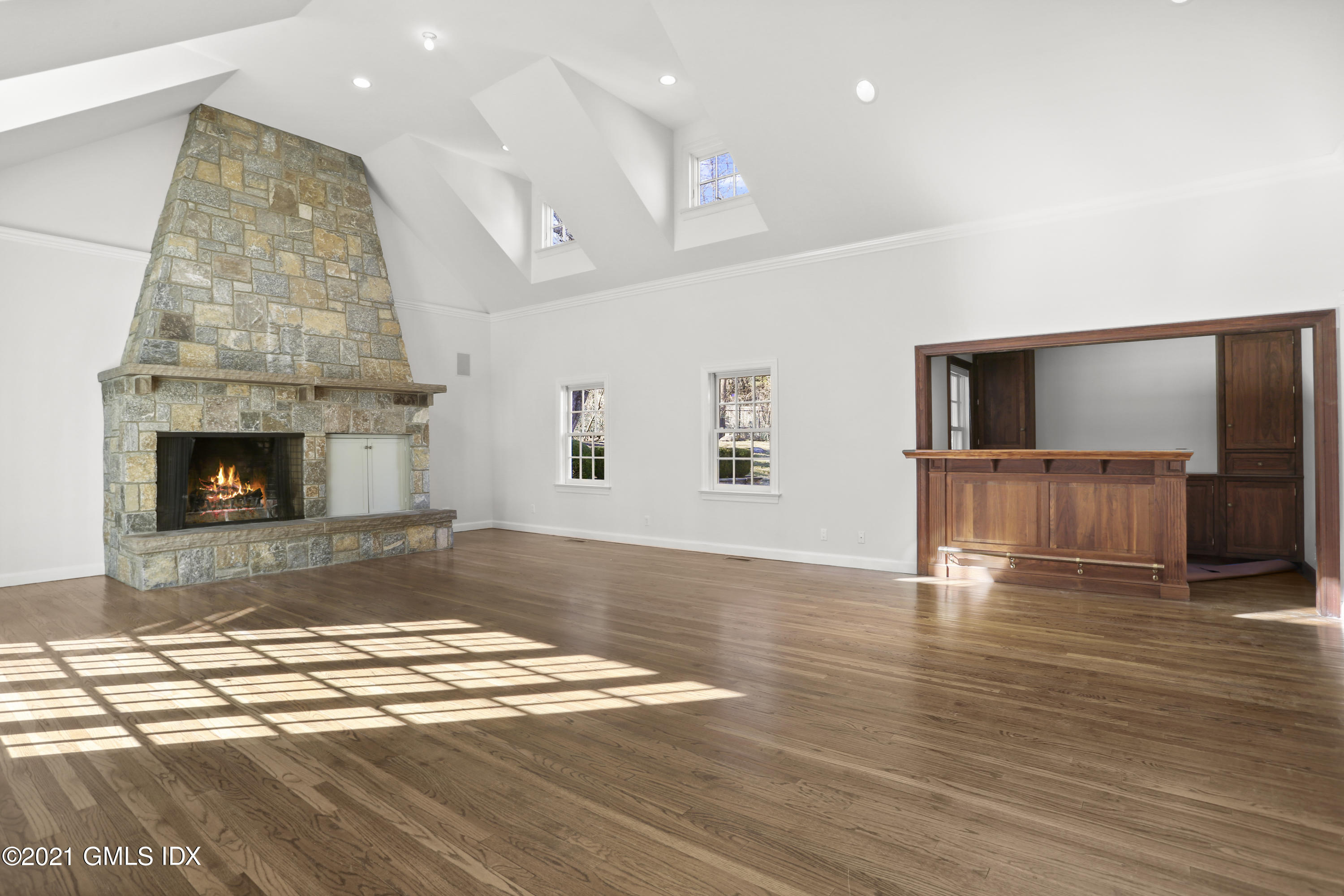 99 Hunting Ridge Road Greenwich, CT 06831 - Photo 8 of 23 a view of empty room with wooden floor and fireplace