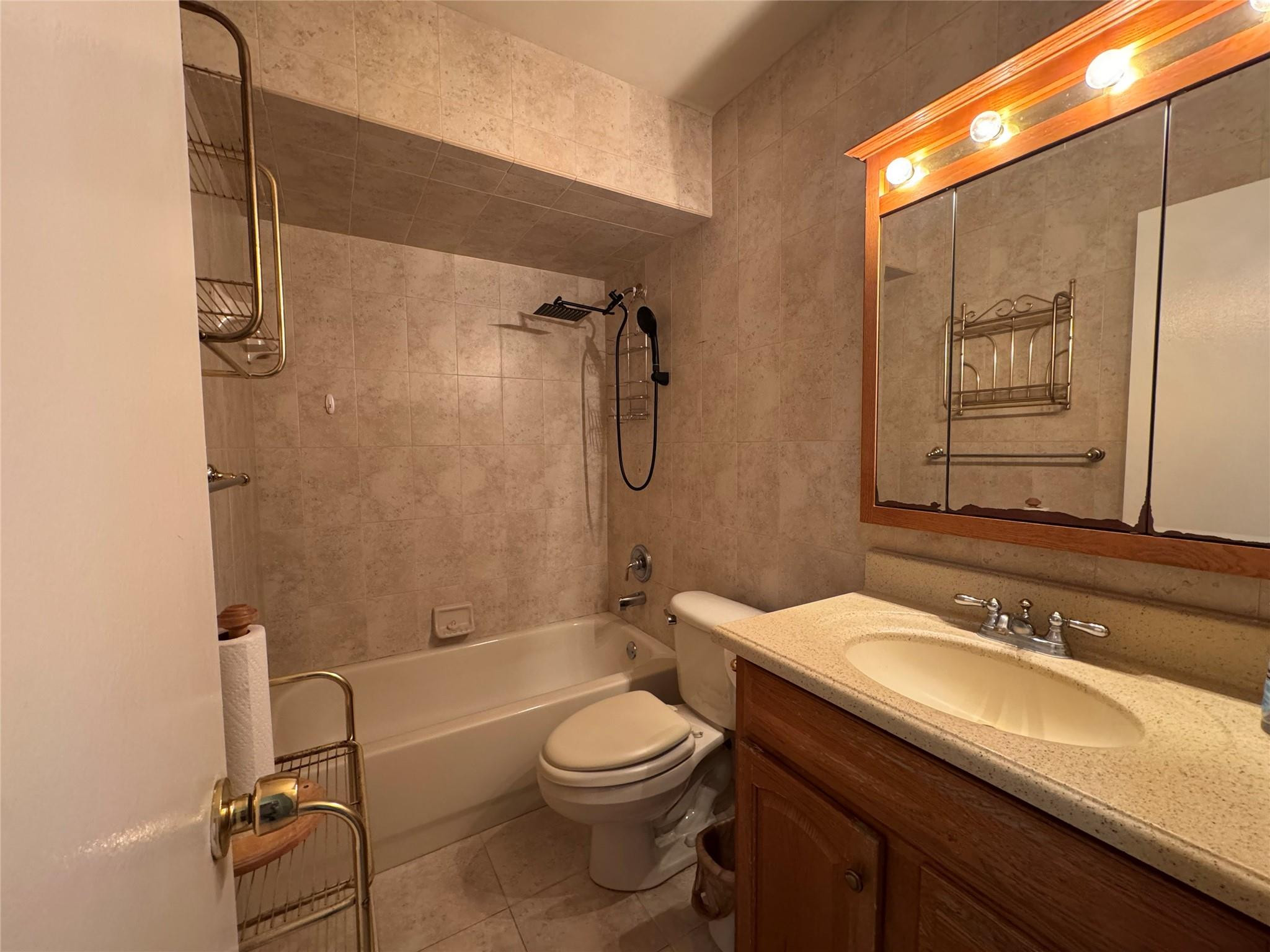 5221 Southwest 201st Terrace Southwest Ranches, FL 33332 - Photo 11 of 15 a bathroom with a granite countertop sink toilet a mirror and shower