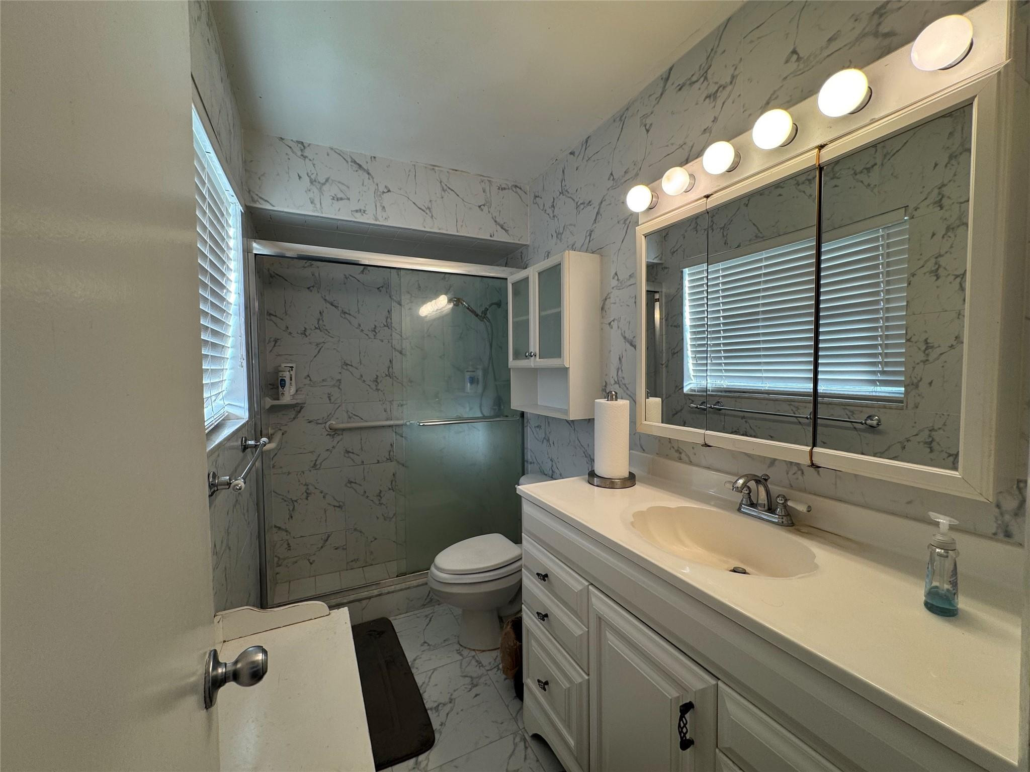 5221 Southwest 201st Terrace Southwest Ranches, FL 33332 - Photo 7 of 15 a bathroom with a double vanity sink toilet and shower