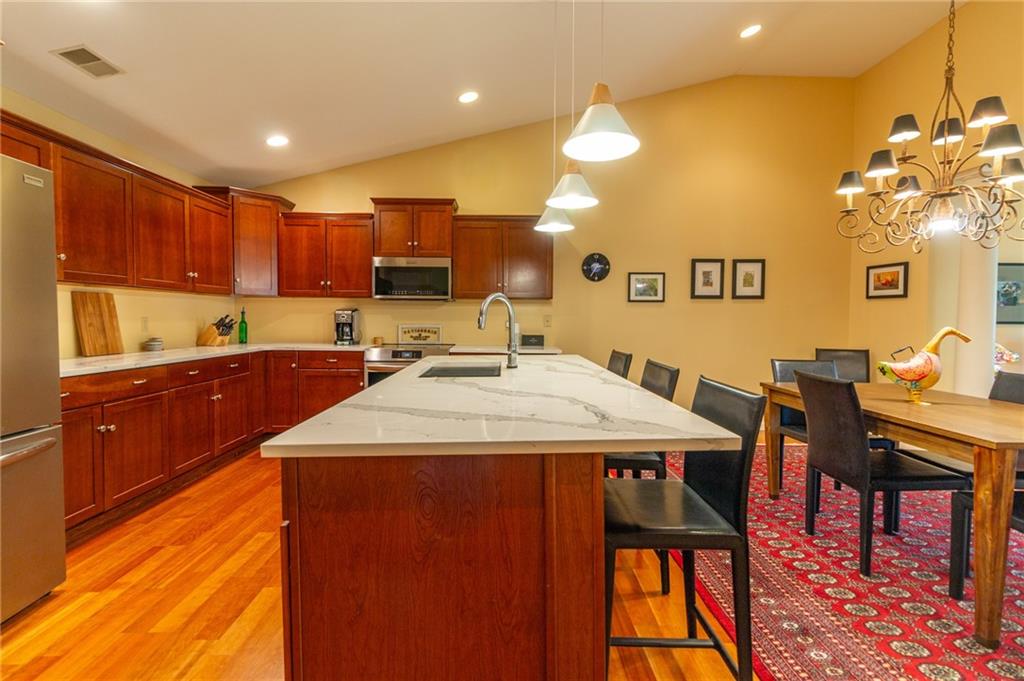 138 Abbey Road New Castle, PA 16105 - Photo 14 of 36 a kitchen with stainless steel appliances kitchen island granite countertop a sink a stove a dining table and chairs