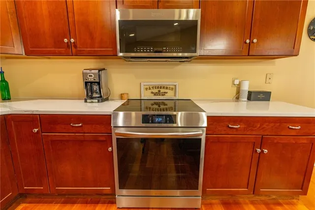 a kitchen with granite countertop a stove and a microwave