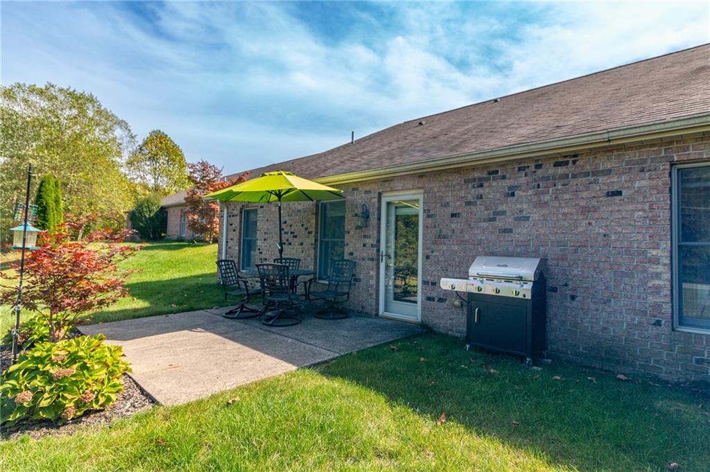 138 Abbey Road New Castle, PA 16105 - Photo 32 of 36 a view of a patio with a table and chairs under an umbrella
