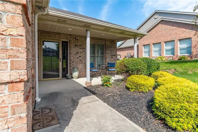 a front view of a house with garden and outdoor seating