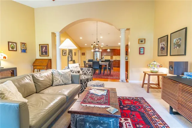 a living room with furniture and a dining table