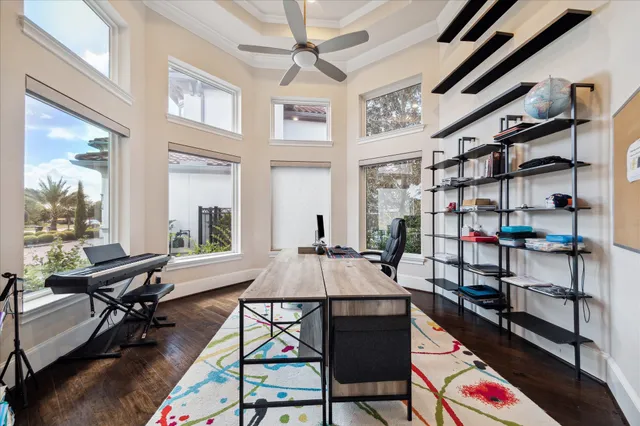 a living room with stainless steel appliances granite countertop furniture wooden floor and a large window