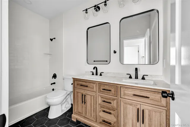 a bathroom with a toilet a sink and a mirror