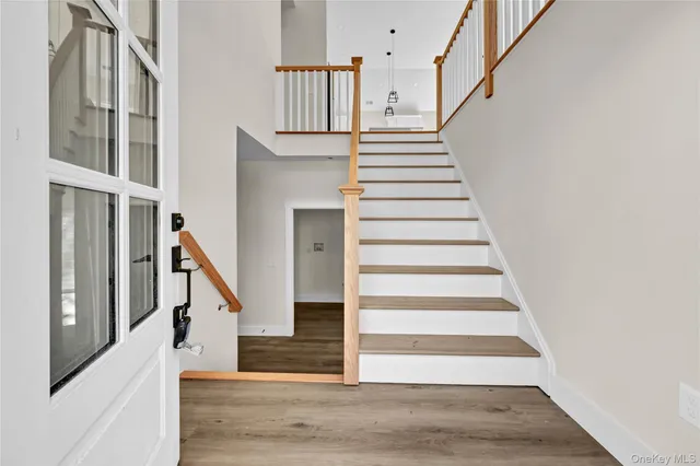 a view of entryway and hall with wooden floor