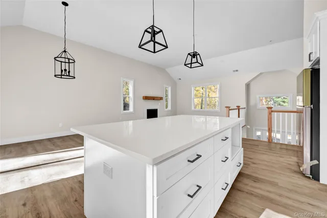 a view of a center island and wooden floor