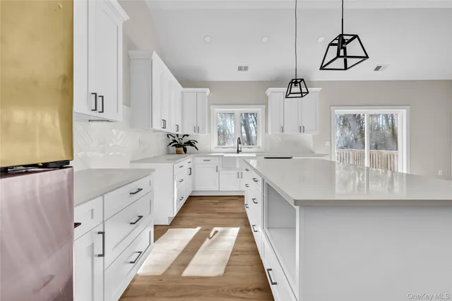 a kitchen with granite countertop a sink stove and cabinets