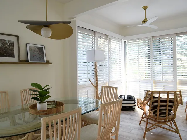 a dining room with furniture a chandelier and wooden floor