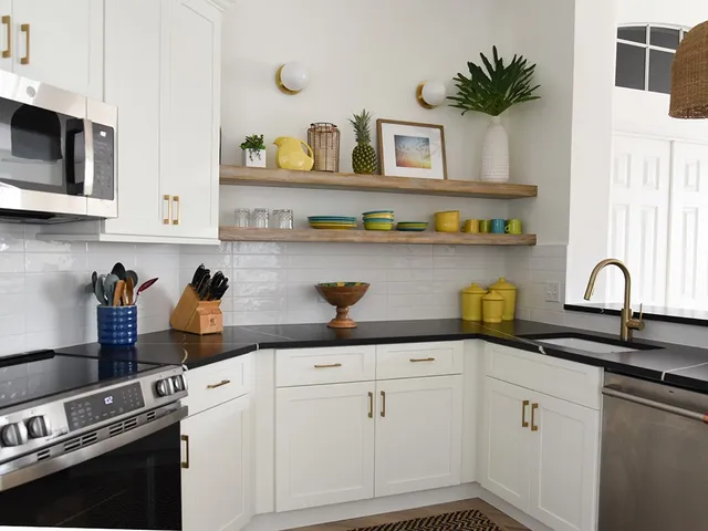 a kitchen with white cabinets and appliances