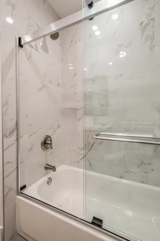 a bathroom with a bathtub and a shower