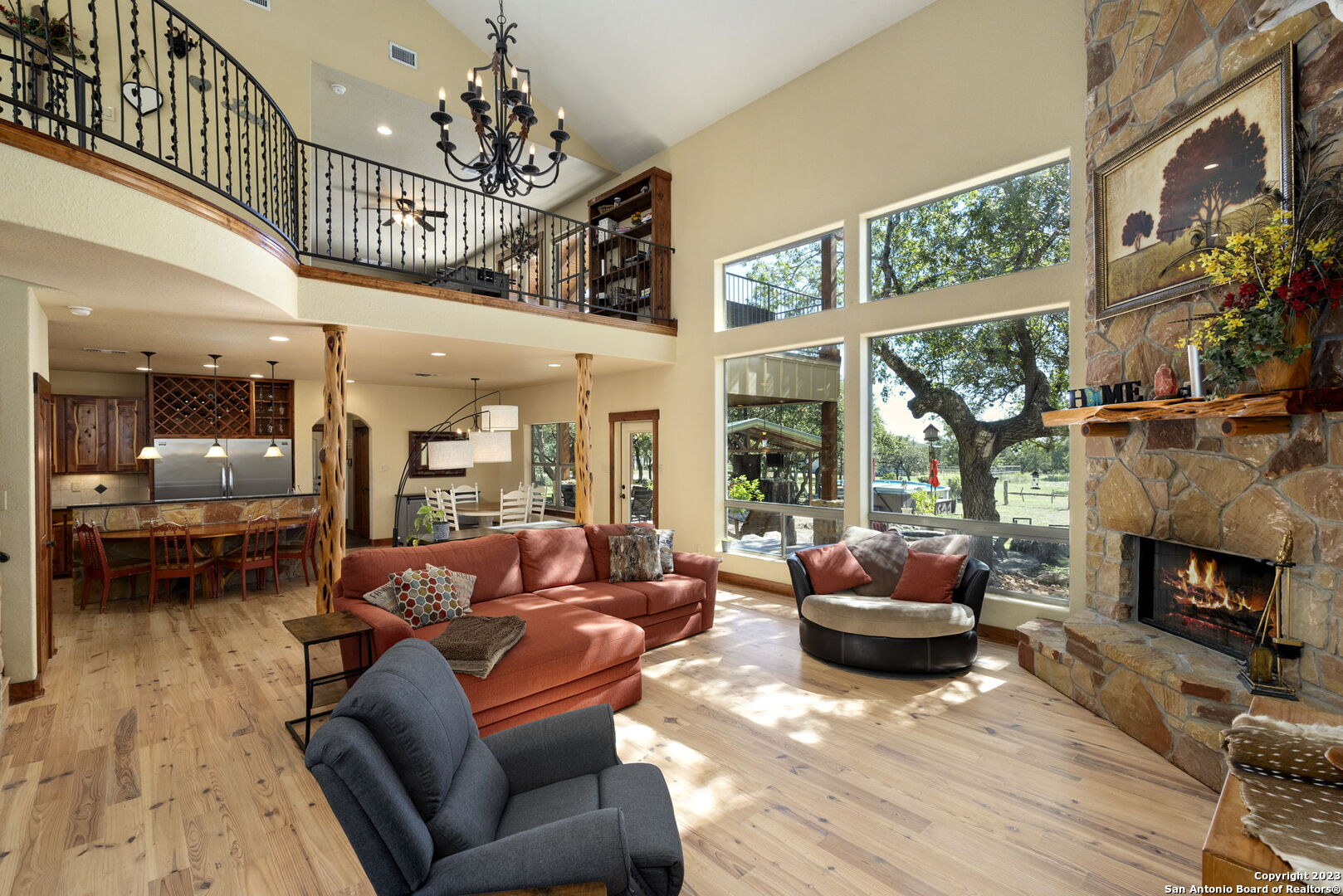 849 Madrona Ridge Drive Bandera, TX 78003 - Photo 1 of 44 a living room with furniture a fireplace and a floor to ceiling window