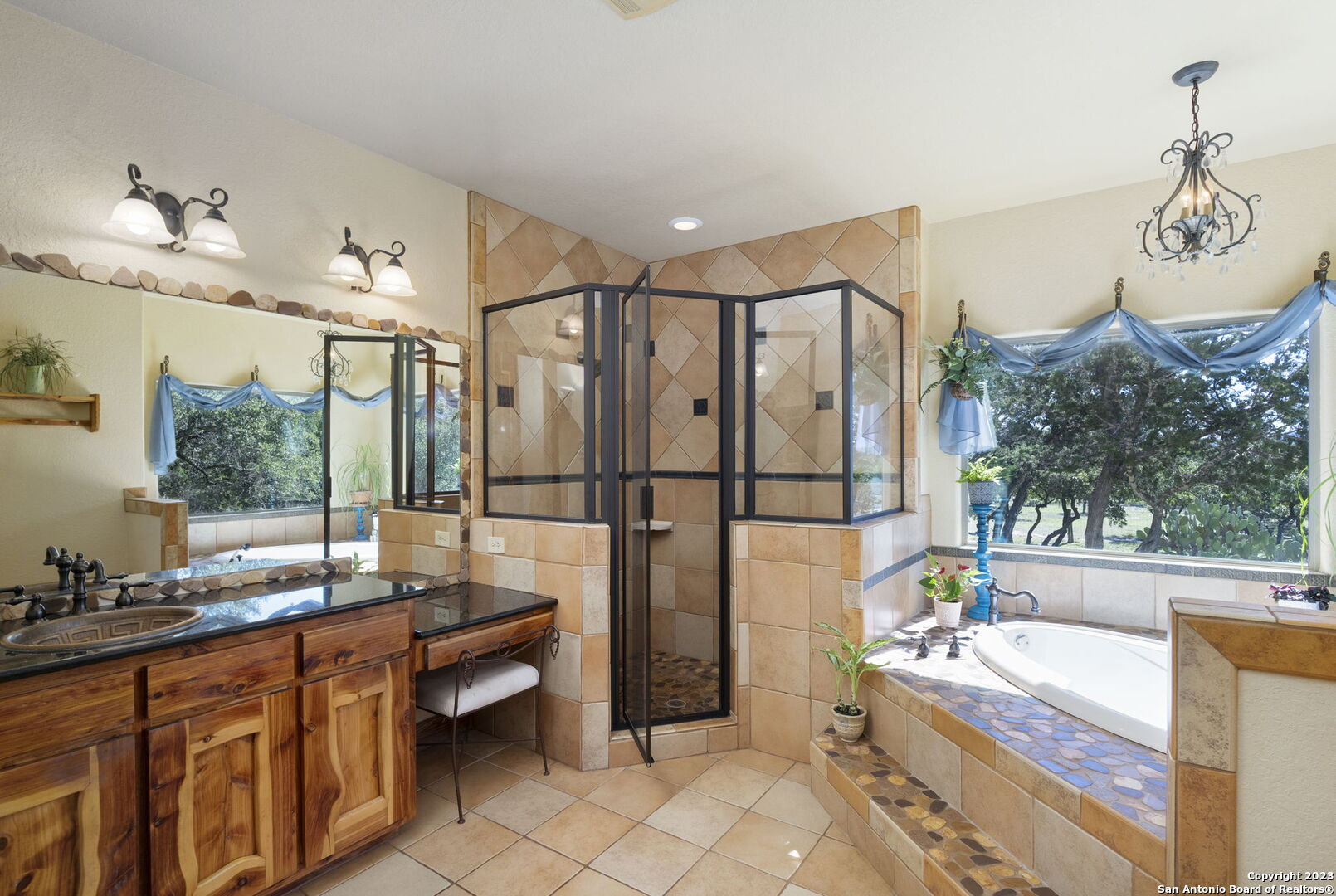 849 Madrona Ridge Drive Bandera, TX 78003 - Photo 23 of 44 a spacious bathroom with a tub sink and mirror
