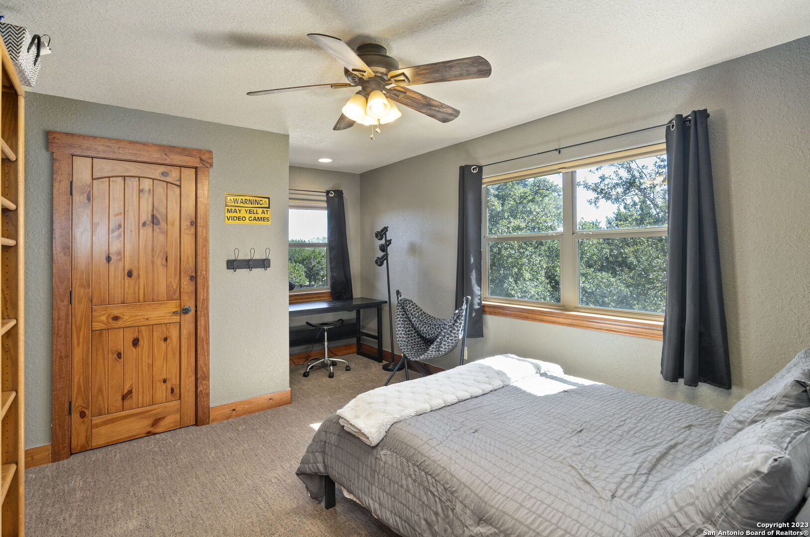 849 Madrona Ridge Drive Bandera, TX 78003 - Photo 32 of 44 a bed sitting in a spacious bedroom next to a window