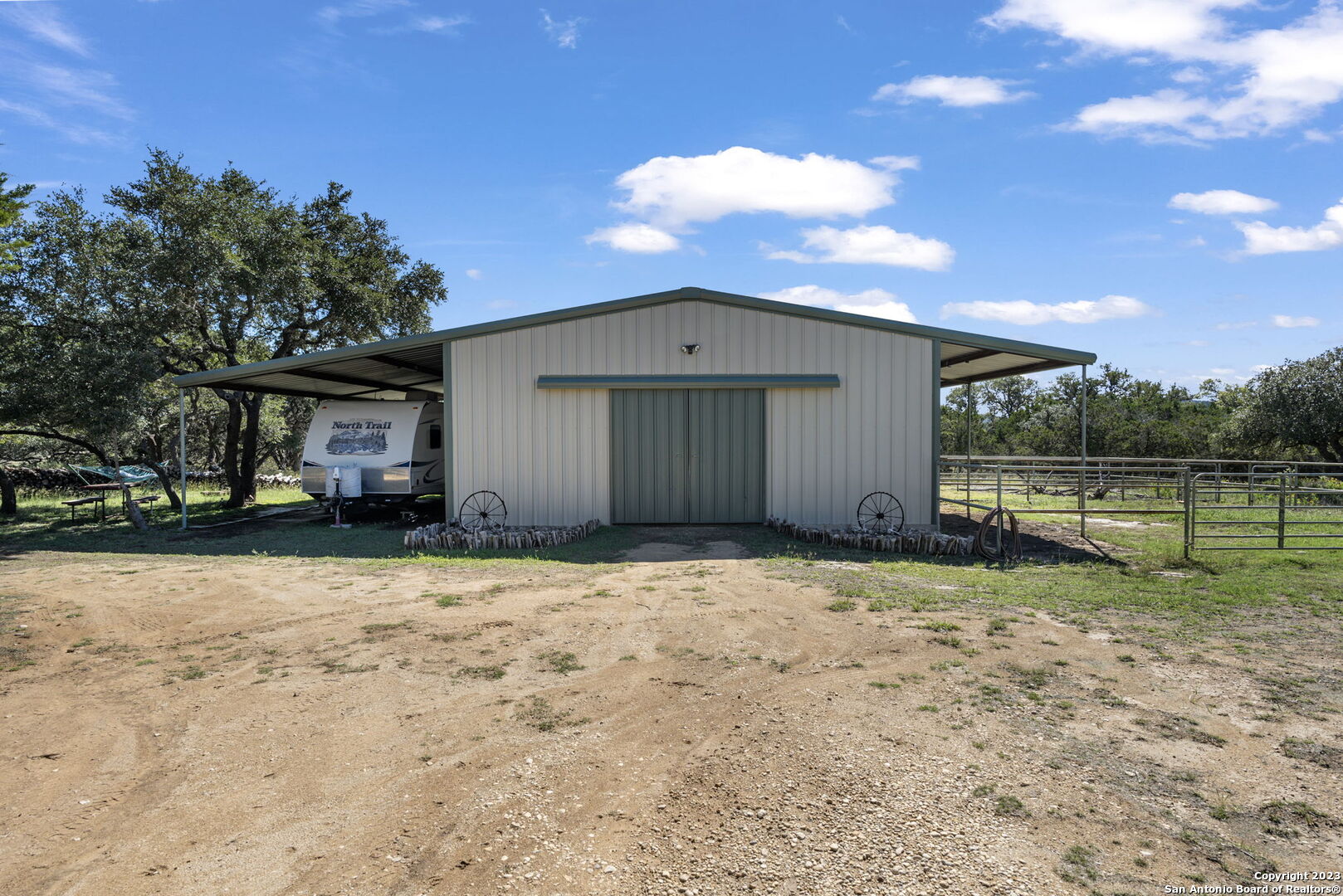 849 Madrona Ridge Drive Bandera, TX 78003 - Photo 6 of 44 a house with trees in the background