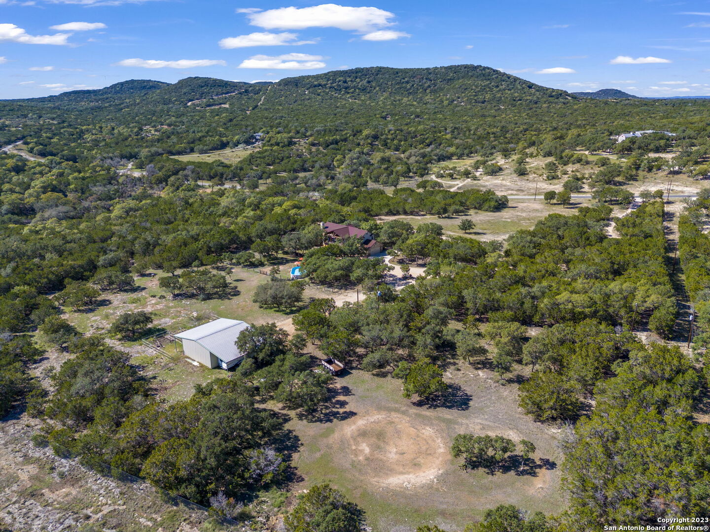 849 Madrona Ridge Drive Bandera, TX 78003 - Photo 9 of 44 an aerial view of residential houses with outdoor space and trees