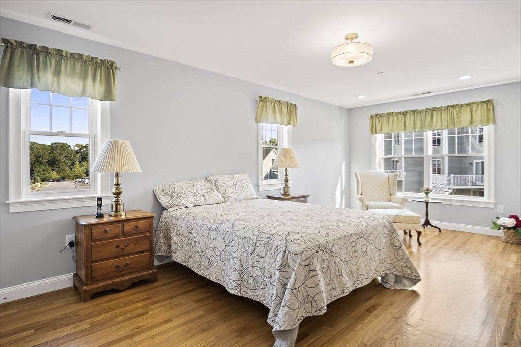 8 Winning Farm Road, Unit 8 Woburn, MA 01801 - Photo 15 of 42 a bedroom with a bed and wooden floor