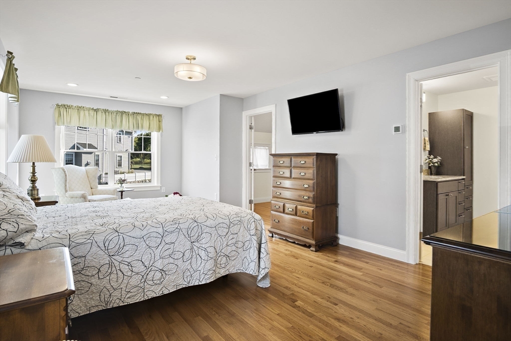 8 Winning Farm Road, Unit 8 Woburn, MA 01801 - Photo 16 of 42 a bedroom with a bed and a flat screen television