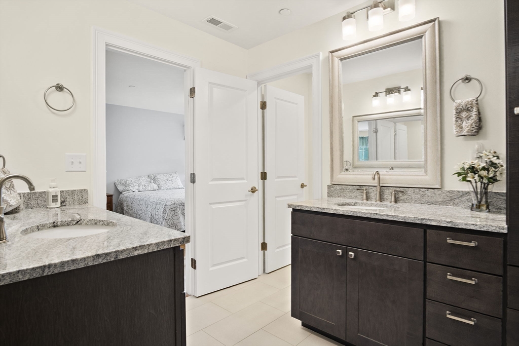 8 Winning Farm Road, Unit 8 Woburn, MA 01801 - Photo 19 of 42 a bathroom with a sink and a mirror