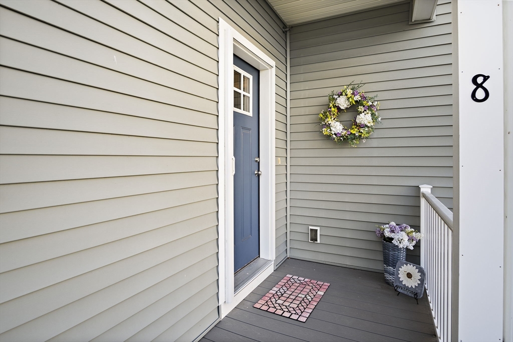 8 Winning Farm Road, Unit 8 Woburn, MA 01801 - Photo 2 of 42 a view of wooden door and a bench