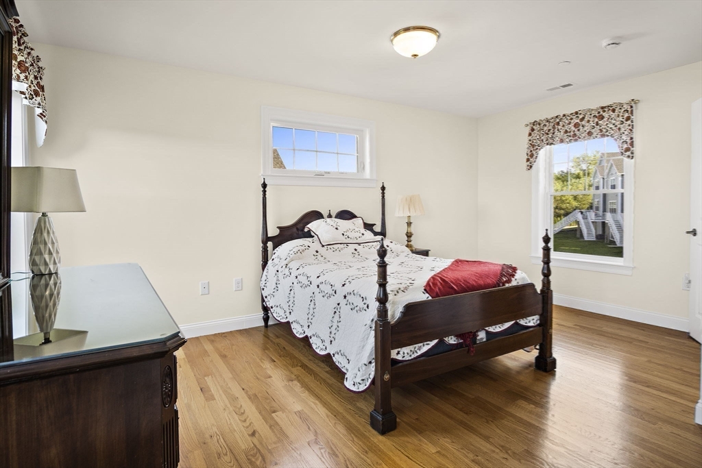 8 Winning Farm Road, Unit 8 Woburn, MA 01801 - Photo 23 of 42 a bedroom with a bed and a night stand