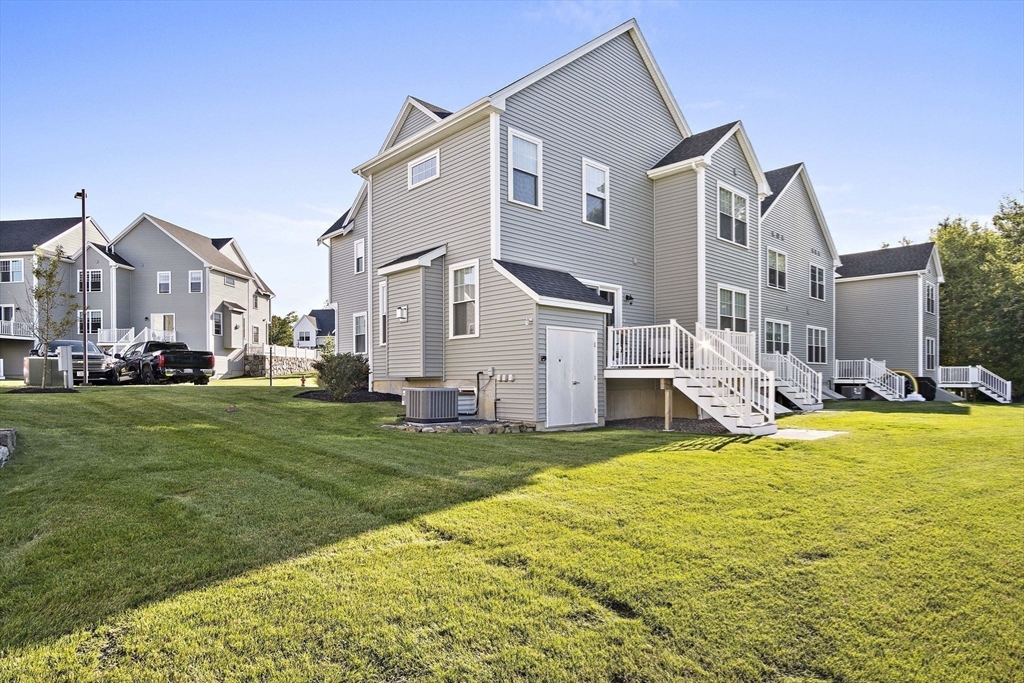 8 Winning Farm Road, Unit 8 Woburn, MA 01801 - Photo 34 of 42 a view of a house with a big yard and large trees