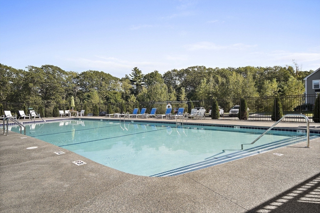 8 Winning Farm Road, Unit 8 Woburn, MA 01801 - Photo 41 of 42 a view of a swimming pool and trees in the background