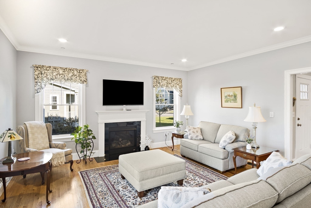 8 Winning Farm Road, Unit 8 Woburn, MA 01801 - Photo 8 of 42 a living room with furniture a flat screen tv and a fireplace