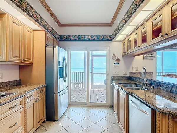 a kitchen with stainless steel appliances granite countertop a sink and cabinets