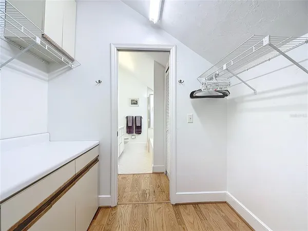 a spacious bathroom with a tub sink and mirror