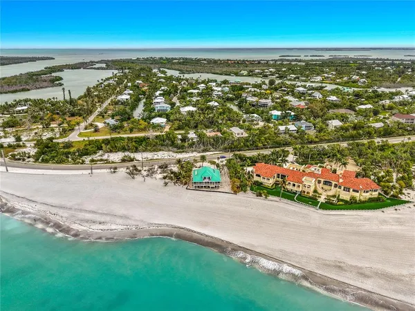 an aerial view of residential building and ocean view