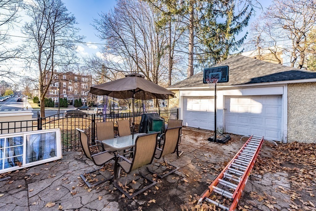 6 Maplewood Terrace Springfield, MA 01108 - Photo 5 of 24 a patio with glass top table and chairs