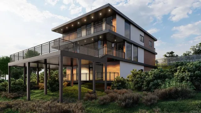 a front view of a house with balcony and garden