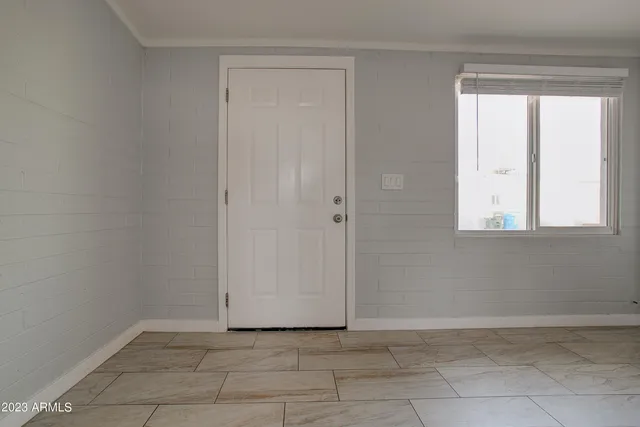 a view of an empty room with a window