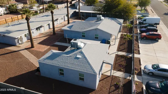 an aerial view of a house with roof deck and furniture