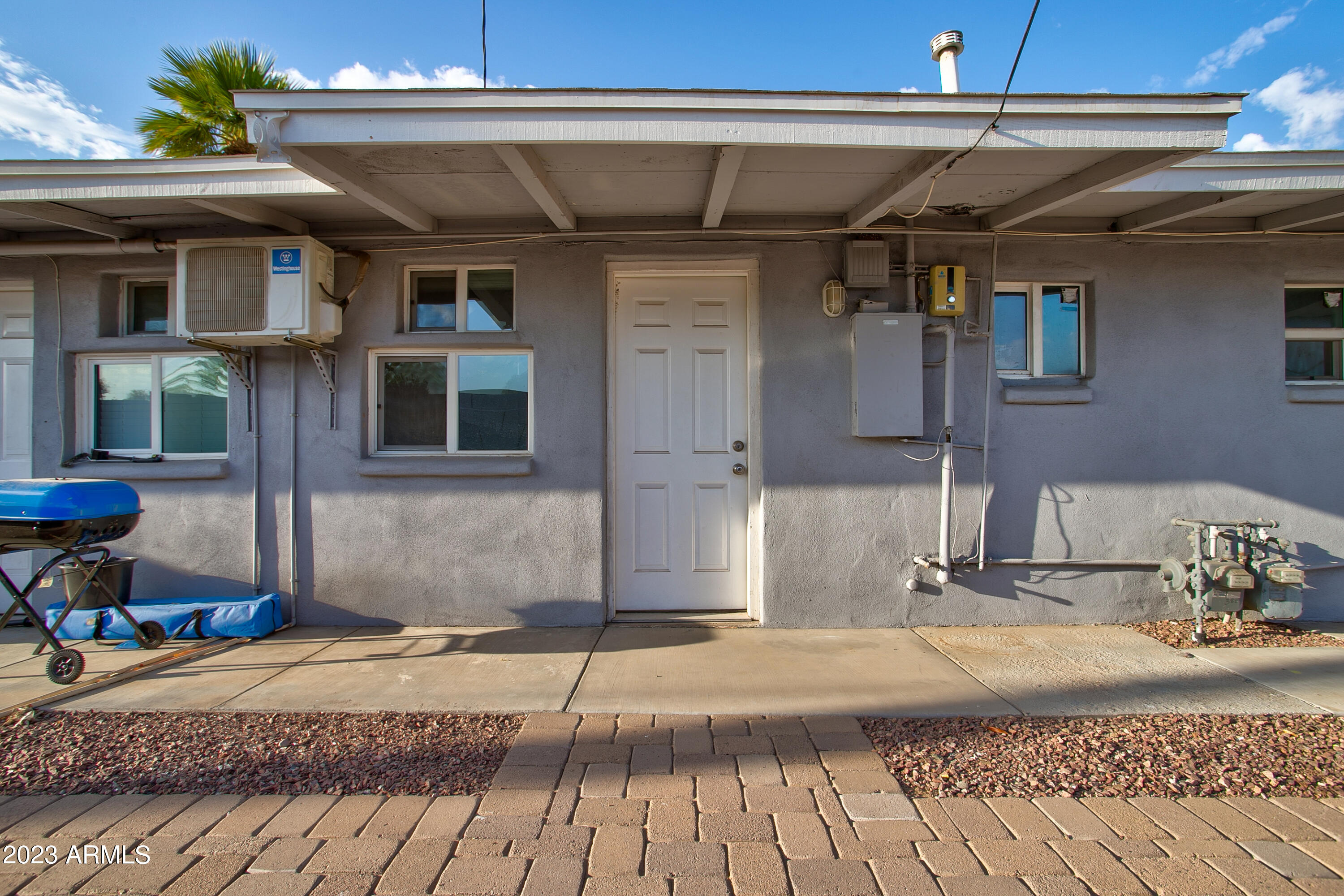 210 East Jones Avenue, Unit 2 Phoenix, AZ 85040 - Photo 24 of 27 a front view of a house with a yard